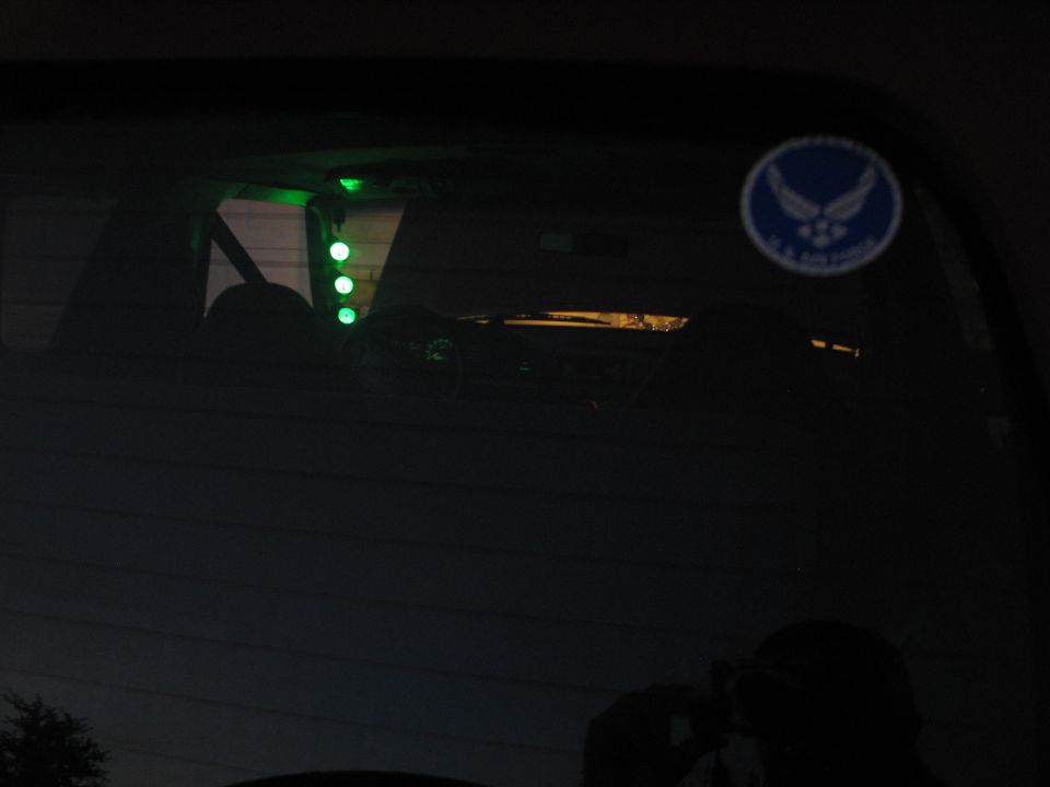 Interior view with green lights and U.S. Air Force sticker on rear window