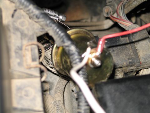 1995 Ford Bronco - Wiring connected to an unidentified automotive electrical part.