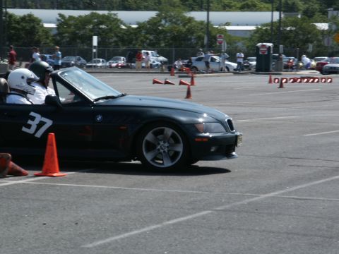 2001 Mercury Grand Marquis - A BMW Z3 convertible with racing number 37 navigates an autocross course on a sunny day.