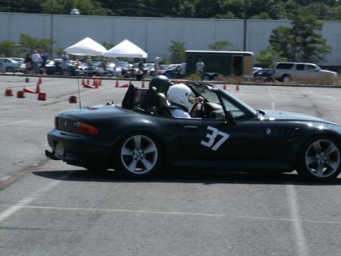 2001 Mercury Grand Marquis - A dark BMW Z3 convertible participates in an autocross event, with two drivers wearing helmets.