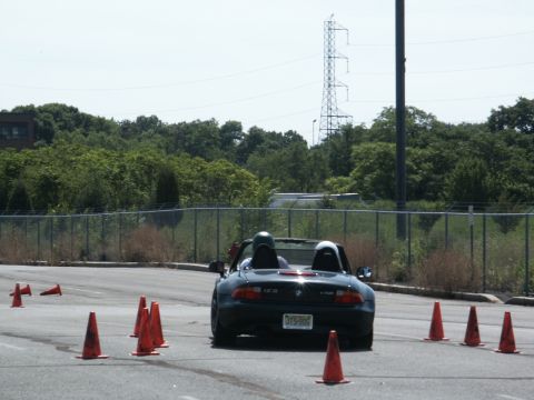 2001 Mercury Grand Marquis - A black convertible sports car navigates a course marked by traffic cones on a sunny day.
