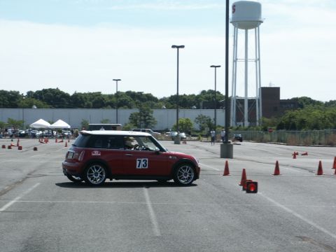 2001 Mercury Grand Marquis - A red Mini Cooper navigates an autocross course marked by orange cones.