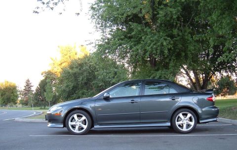 2005 Mazda 6 - Side view of a dark gray 2005 Mazda 6 sedan parked in a lot.