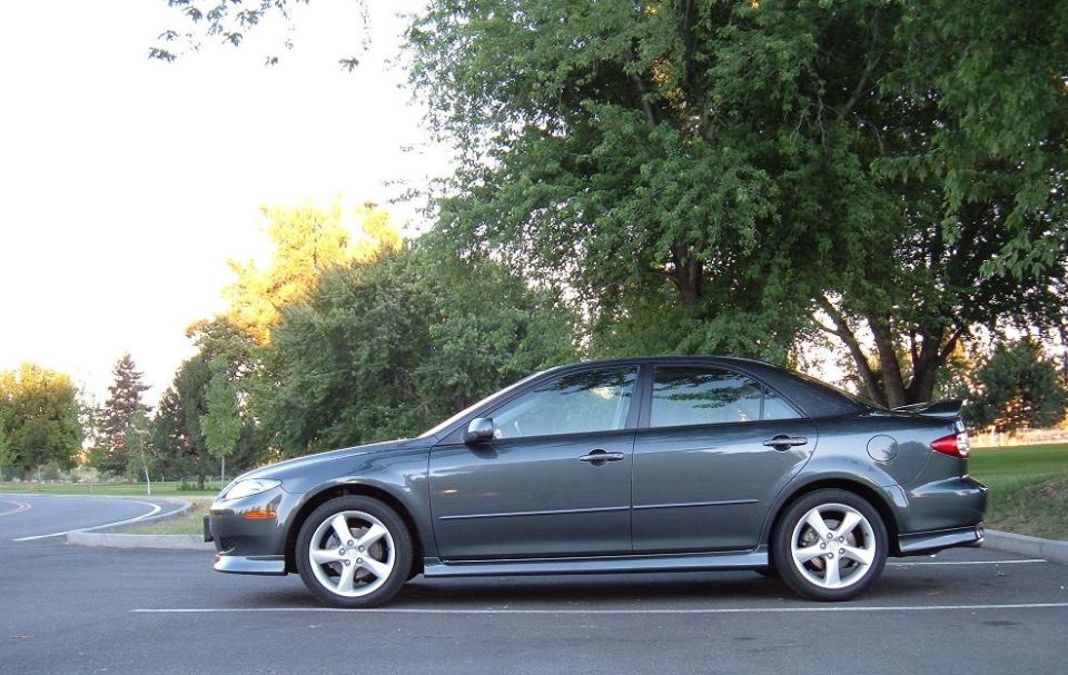 2005 Mazda 6 sedan parked in a lot with trees in the background