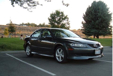 2005 Mazda 6 - A dark gray 2005 Mazda 6 sedan is parked in a lot on a sunny day.