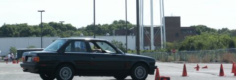 2001 Mercury Grand Marquis - A black coupe with racing number 7 on its door navigates a course marked by orange cones.