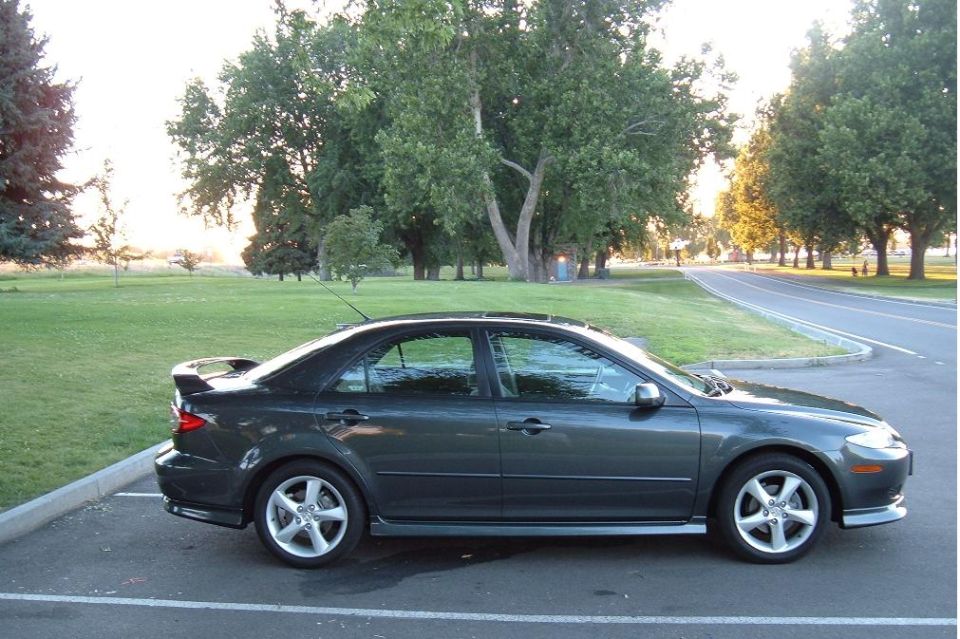 Dark gray 2005 Mazda 6 sedan parked, side view, with a rear spoiler and alloy wheels