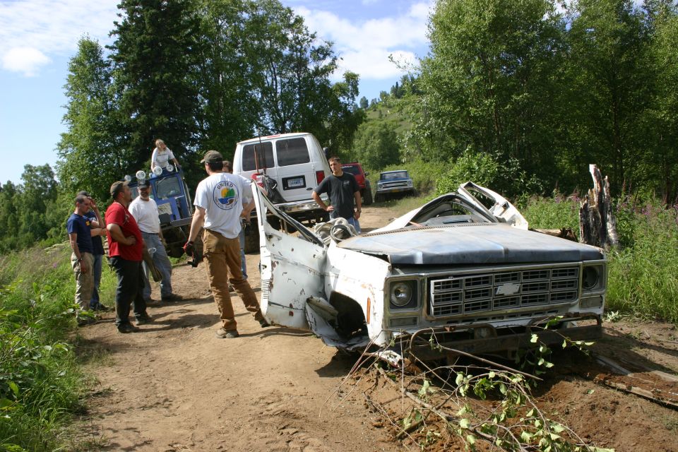 Front view of a wrecked white pickup truck with a Chevrolet grille