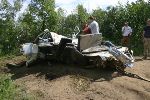 2003 Jeep TJ - Wrecked pickup truck being recovered from a ditch with people observing the scene.