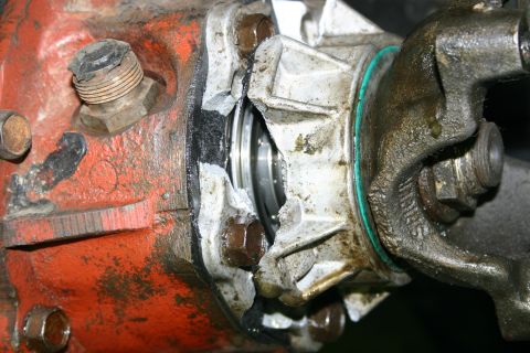 2003 Jeep TJ - Close-up of a damaged differential housing showing a torn seal and fractured metal components.
