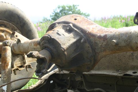 2003 Jeep TJ - Close-up of a heavily rusted rear axle assembly, likely from an older vehicle.
