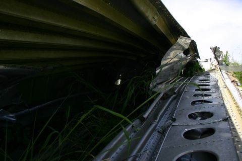 2003 Jeep TJ - Damaged aircraft fuselage wreckage with visible rivets and internal structure.