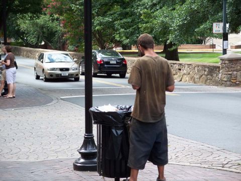 1971 Ford Ranchero - Two sedans are seen on a street with a man standing by a trash can.