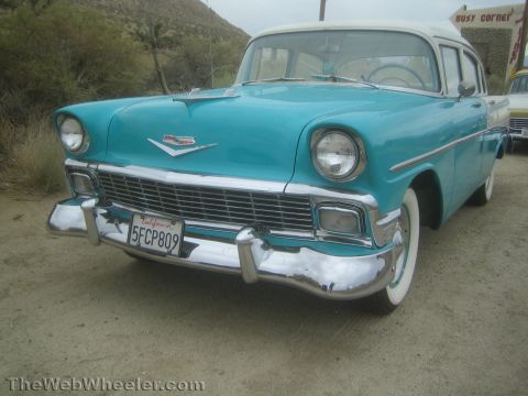 1990 Ford Bronco - Front three-quarter view of a turquoise and white 1956 Chevrolet sedan with whitewall tires and a California license plate.