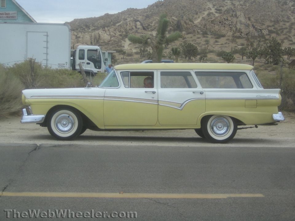 Yellow and white 1957 Ford station wagon, side profile view