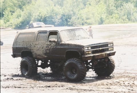 1991 Chevrolet Suburban - This lifted 1991 Chevrolet Suburban navigates through a muddy terrain, its off-road capabilities.