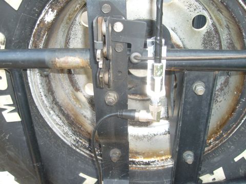 1992 Ford Bronco - Close-up of a CB antenna mount on a vehicle's spare tire carrier.
