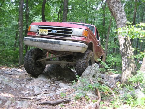 1990 Ford Bronco - This 1990 Ford Bronco navigates a challenging off-road course with large tires and lifted suspension.