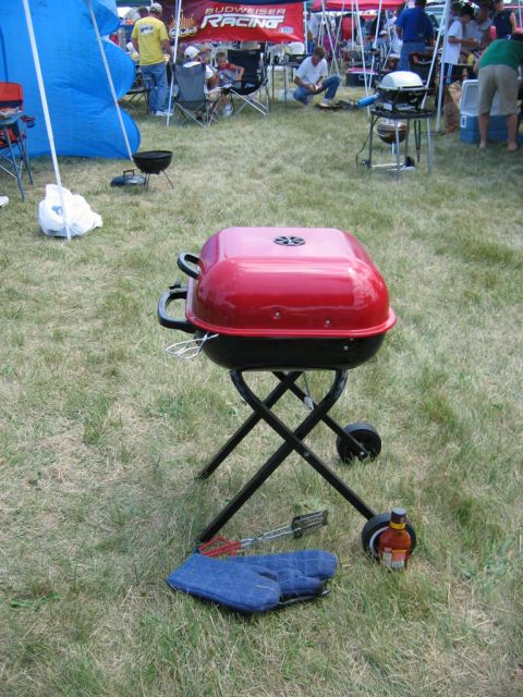 1985 Ford Crown Victoria LTD - Portable grill set up on grass with barbecue accessories nearby.