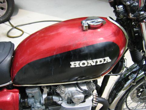 1985 Ford Crown Victoria LTD - Close-up of a red and black Honda motorcycle fuel tank, showing the HONDA logo.