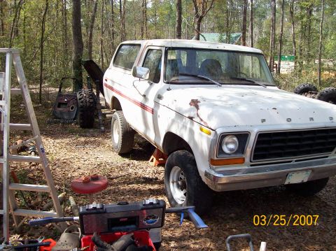 1978 Ford Bronco - 1978 Ford Bronco parked outdoors with tools and parts around it.