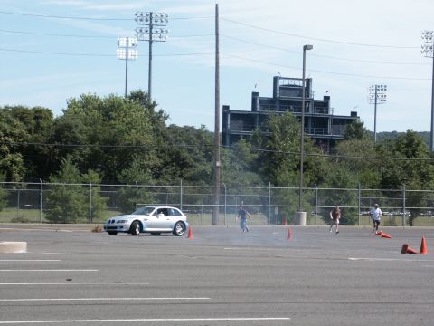 2001 Mercury Grand Marquis - A silver BMW Z3 Coupe is seen on a paved lot during an event with cones and people running.