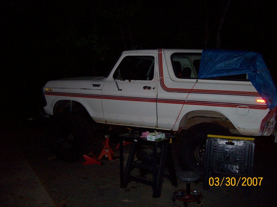1978 Ford Bronco side view, white with red pinstripes, on jack stands