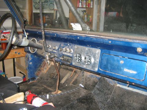 1992 Ford Mustang - The interior of a classic Ford Bronco shows its dashboard, steering wheel, and floor-mounted pedals.