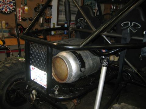 1992 Ford Mustang - Custom off-road vehicle with a prominent fuel tank and roll cage is seen from the rear.