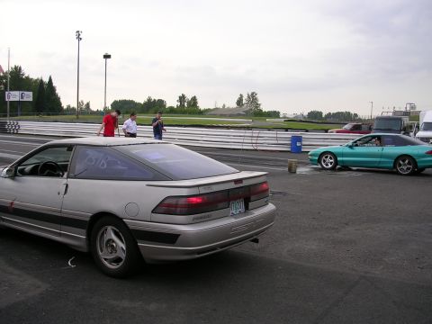 1996 Ford Probe - Silver 1996 Ford Probe seen from the rear at a drag strip, with a teal Ford Probe in the background.