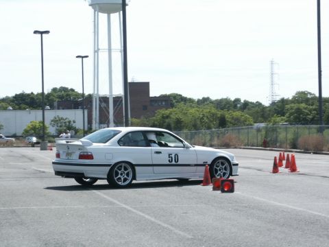 2001 Mercury Grand Marquis - A white coupe with racing number 50 is positioned on an asphalt lot with orange cones.