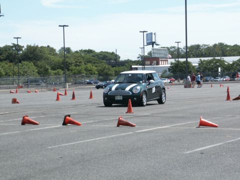 2001 Mercury Grand Marquis - A Mini Cooper navigates a course marked by orange traffic cones on a sunny day.