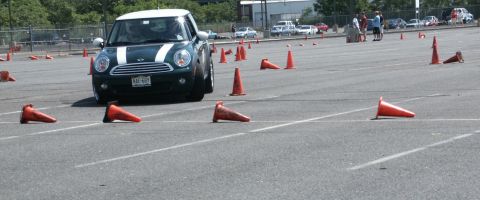 2001 Mercury Grand Marquis - A green Mini Cooper navigates an autocross course marked by orange cones.