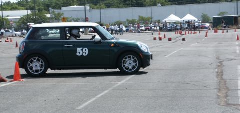 2001 Mercury Grand Marquis - A green Mini Cooper with a white roof and the number 59 on its side navigates an autocross course.