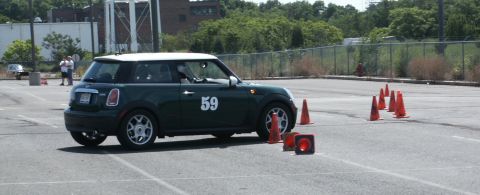 2001 Mercury Grand Marquis - Mini Cooper participating in an autocross event on a paved lot with cones.