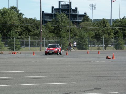 2001 Mercury Grand Marquis - A red Mini Cooper navigates an autocross course marked by orange cones.