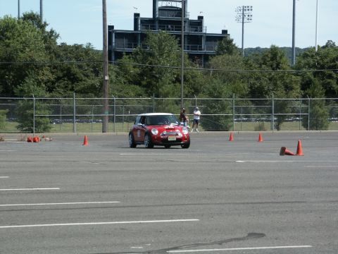 2001 Mercury Grand Marquis - A red Mini Cooper navigates a course marked by orange cones on a sunny day.