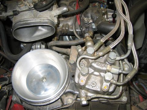 1987 Suzuki Samurai - Engine bay detail showing fuel injection components and throttle body assembly.
