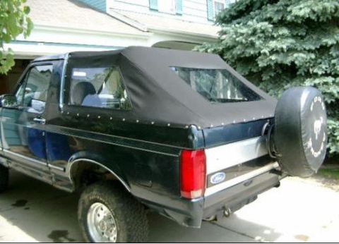1995 Ford Bronco - Rear view of a 1995 Ford Bronco, a soft top and external spare tire.