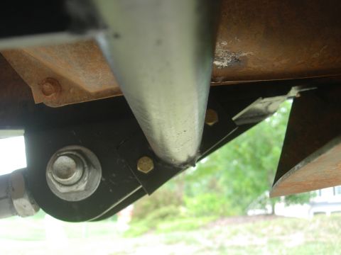 1995 Ford Bronco - Underside view of a vehicle's suspension component, showing a bolted bracket.