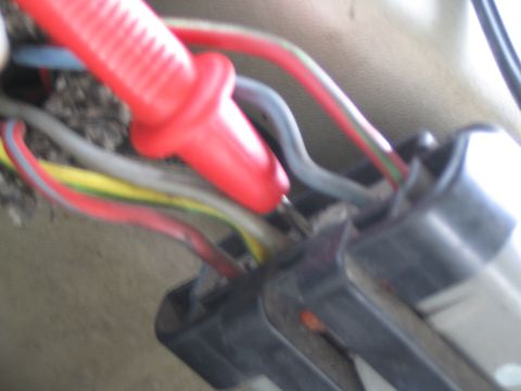 1993 Ford Taurus - A red probe is shown making contact with electrical connectors and wiring.