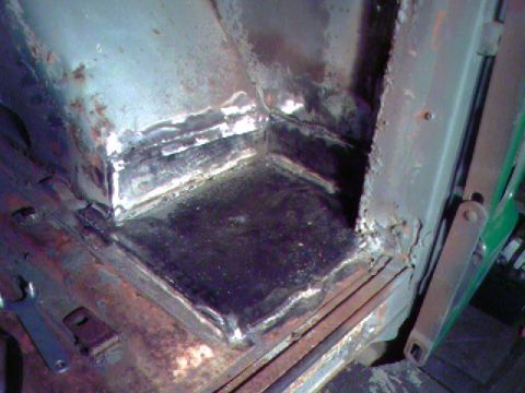 1974 Ford Bronco - Metal repair work in the interior corner of a vehicle, showing rust and fresh welds.