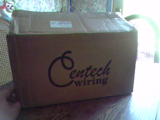 Cardboard box with Centech wiring logo on a wooden table