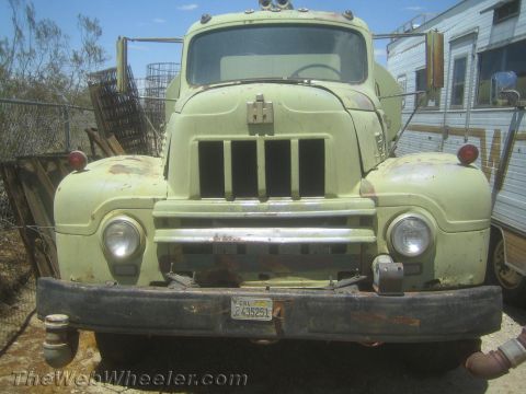 1990 Ford Bronco - front end of a pale green vintage International Harvester truck with a vertical-bar grille and a yellow California license plate.