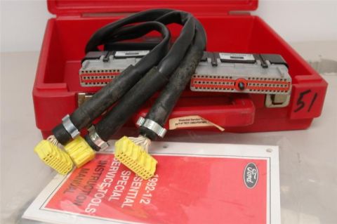 1994 Ford Probe - A red case holds Ford diagnostic connectors and cables, alongside a service manual.