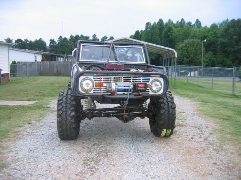 1992 Ford Mustang - This modified Ford Bronco features oversized tires and a winch, indicating it is built for off-road use.