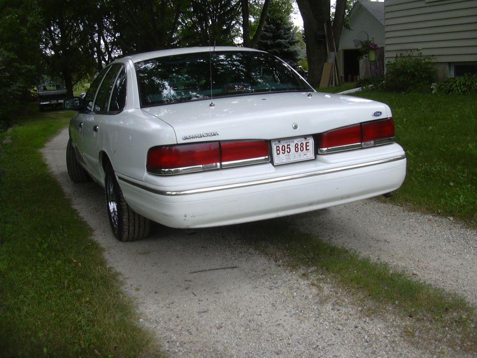 White 1997 Ford Crown Victoria rear view with license plate B95 88E