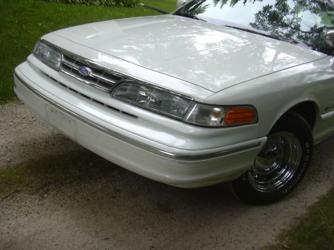 1997 Ford Crown Victoria - Front view of a white 1997 Ford Crown Victoria showing the grille and headlights.