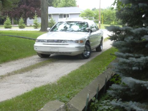 1997 Ford Crown Victoria - White 1997 Ford Crown Victoria parked on a gravel driveway.