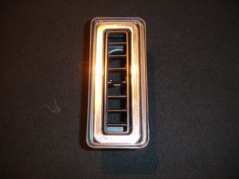 1977 Ford F-150 - A single chrome-trimmed air vent is shown against a dark background.
